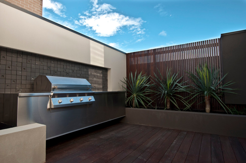 Photo of a mid-sized modern backyard patio in Melbourne with an outdoor kitchen, decking and no cover.