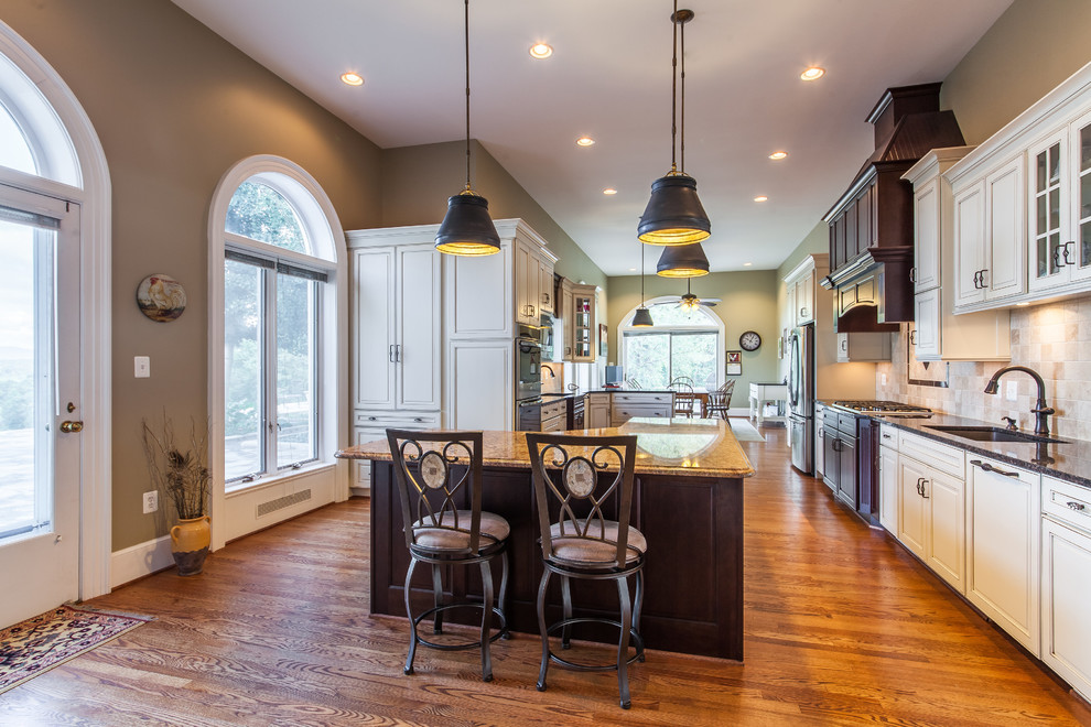 Example of a huge transitional medium tone wood floor eat-in kitchen design in DC Metro with raised-panel cabinets, granite countertops, stainless steel appliances and an island