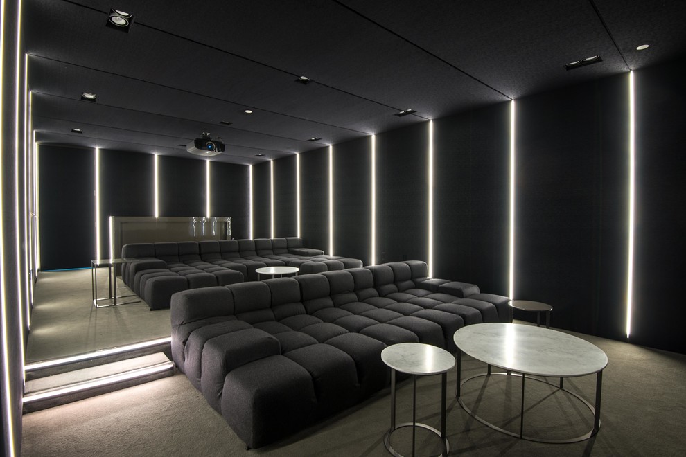 Photo of a contemporary home theatre in Los Angeles with black walls.