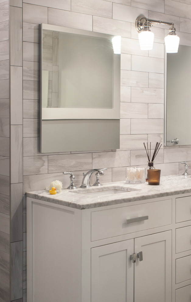 Example of a mid-sized transitional master gray tile and porcelain tile ceramic tile and gray floor bathroom design with flat-panel cabinets, white cabinets, beige walls, marble countertops and an undermount sink