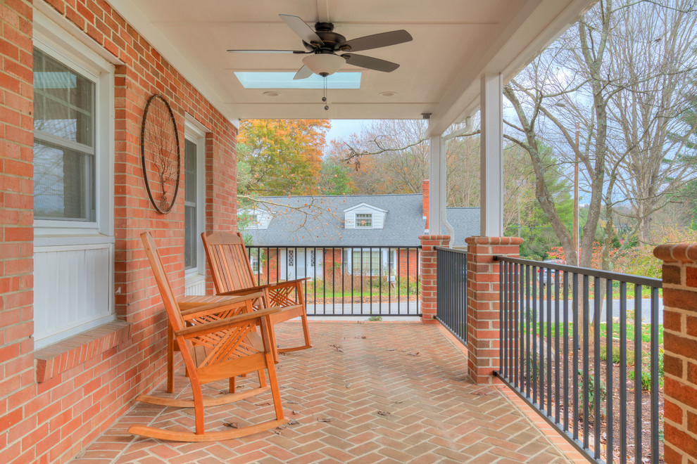 Photo of an arts and crafts front yard verandah in Other with brick pavers and a roof extension.