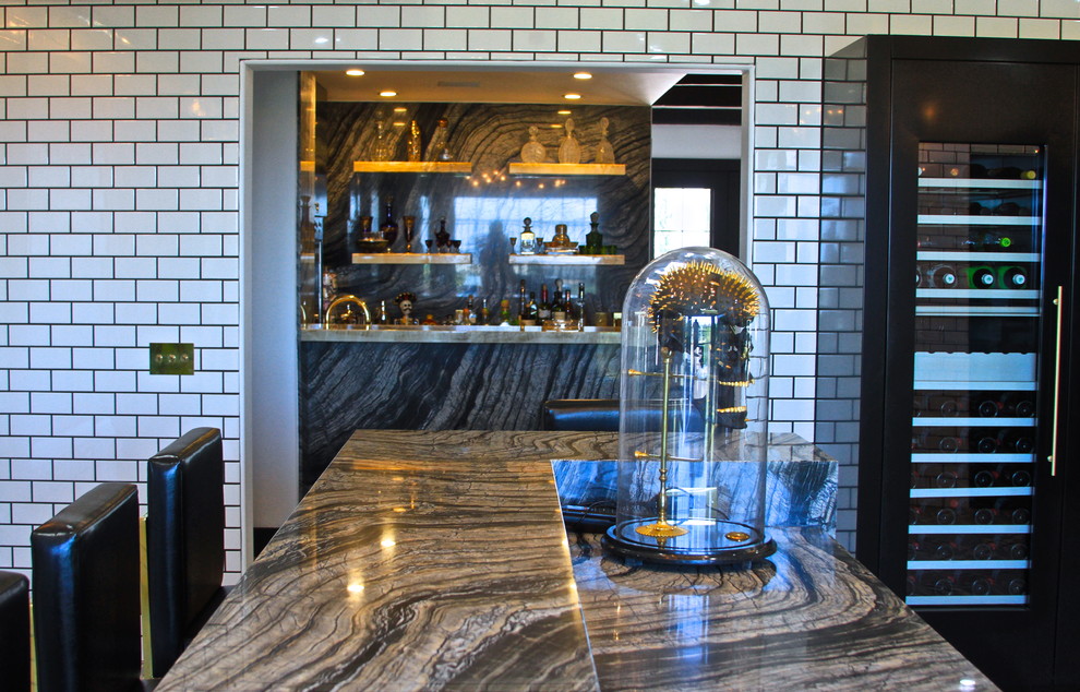 Inspiration for a huge eclectic l-shaped ceramic tile enclosed kitchen remodel in Orange County with an undermount sink, flat-panel cabinets, gray cabinets, marble countertops, white backsplash, subway tile backsplash, black appliances and an island