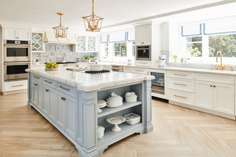 Design ideas for a traditional eat-in kitchen in Los Angeles with white cabinets, quartz benchtops, blue splashback, stainless steel appliances, white benchtop, beaded inset cabinets, marble splashback, porcelain floors, beige floor and a drop-in sink.