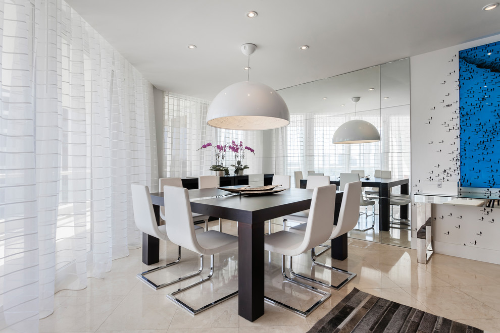 This is an example of a small contemporary open plan dining in Miami with white walls.