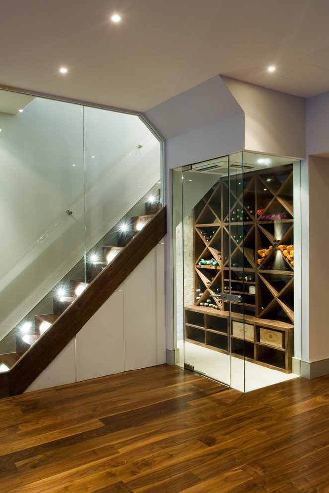 This is an example of a contemporary wine cellar in London with white floor.