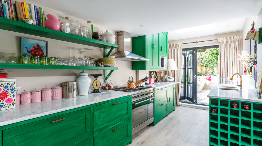 Eclectic galley kitchen in New York with an undermount sink, green cabinets, stainless steel appliances, light hardwood floors, no island, beige floor and recessed-panel cabinets.