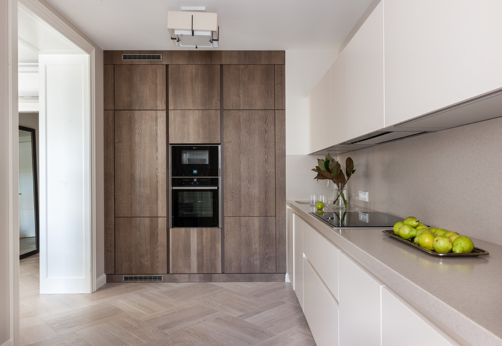 Contemporary l-shaped kitchen in Moscow with flat-panel cabinets, beige splashback, black appliances, light hardwood floors, no island, beige floor and white cabinets.