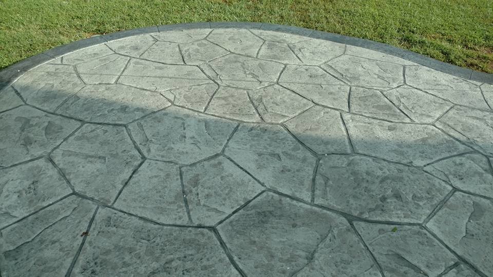 Large traditional backyard patio in Other with a fire feature, stamped concrete and no cover.