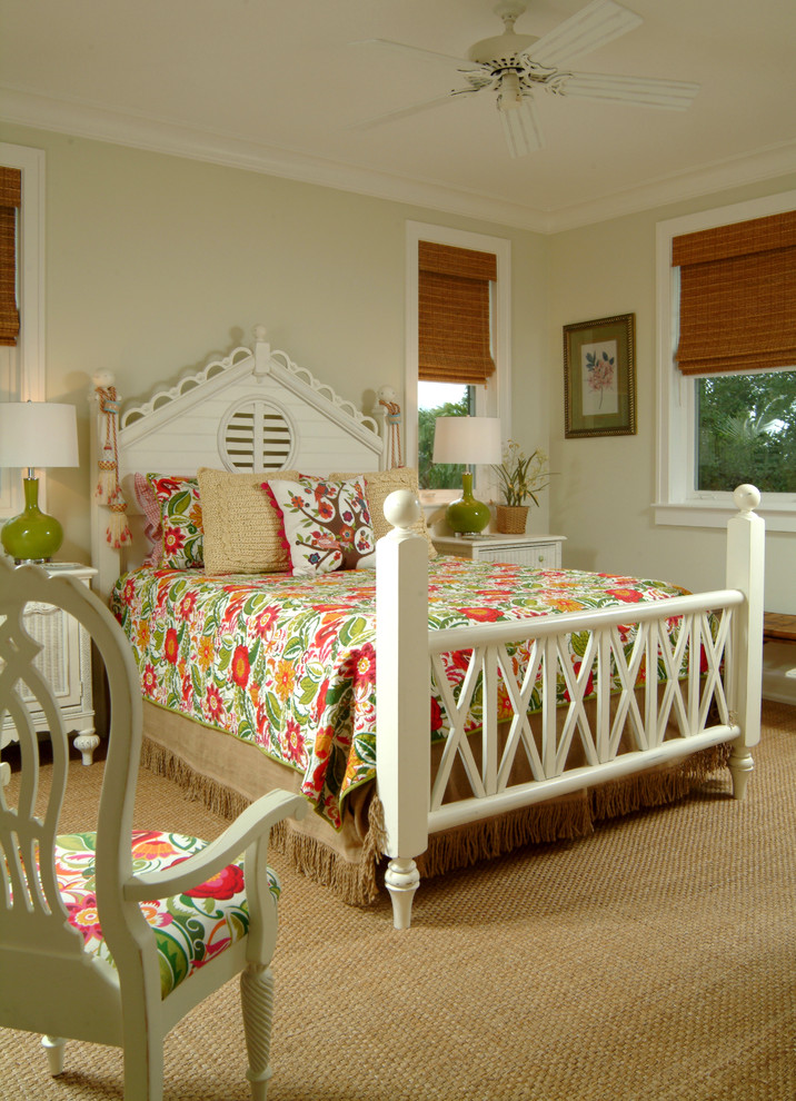 This is an example of a mid-sized tropical guest bedroom in Miami with beige walls and carpet.