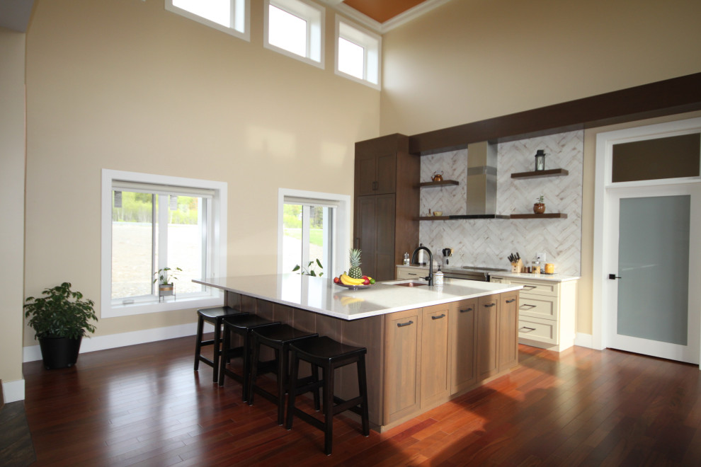 This is an example of a large modern l-shaped kitchen/diner in Other with a submerged sink, shaker cabinets, medium wood cabinets, composite countertops, white splashback, metro tiled splashback, stainless steel appliances, medium hardwood flooring, an island, brown floors, white worktops and a coffered ceiling.