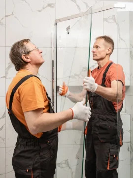 remodelers moving glass in shower