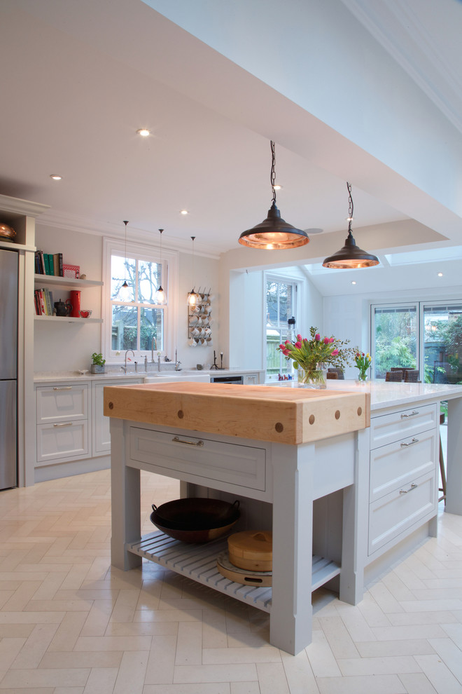 Design ideas for a country kitchen in London with limestone floors.