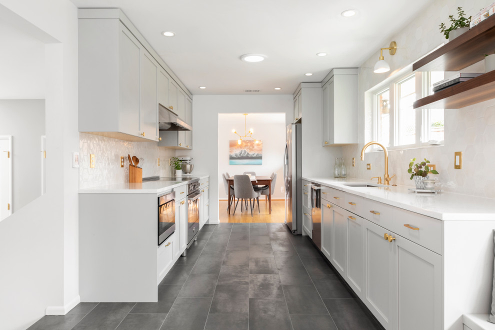 Inspiration for a large modern galley separate kitchen in Seattle with an undermount sink, shaker cabinets, grey cabinets, quartz benchtops, white splashback, engineered quartz splashback, stainless steel appliances, porcelain floors, no island, black floor and white benchtop.