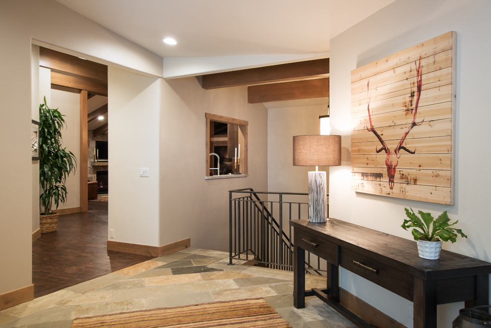 Mid-sized mountain style slate floor foyer photo with beige walls