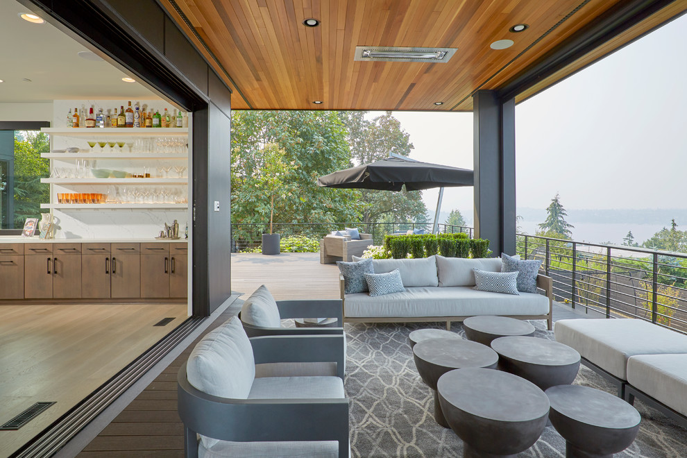 Inspiration for a large contemporary deck in Seattle with a roof extension.