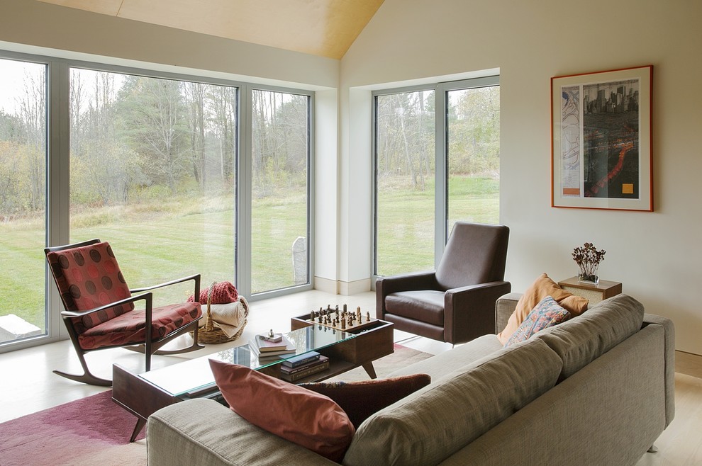 Inspiration for a mid-sized farmhouse open concept light wood floor living room remodel in Boston with white walls and no tv