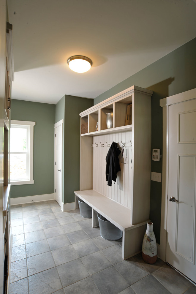 Traditional mudroom in Columbus with green walls, a single front door and a white front door.