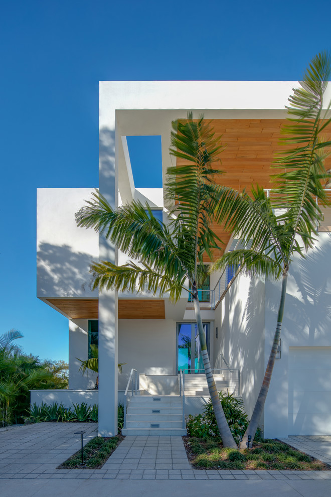 This is an example of a large contemporary front door in Tampa with white walls, concrete floors, a double front door, a glass front door and white floor.