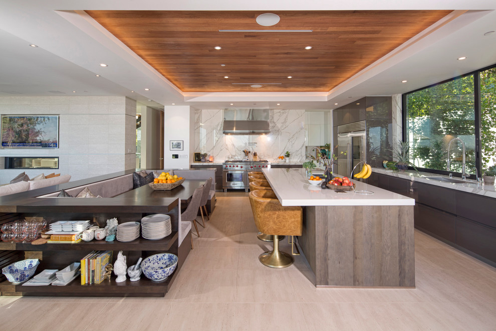 Photo of a large contemporary l-shaped open plan kitchen in Los Angeles with an undermount sink, flat-panel cabinets, stainless steel appliances, with island, grey cabinets, quartz benchtops, white splashback, marble splashback, porcelain floors and beige floor.