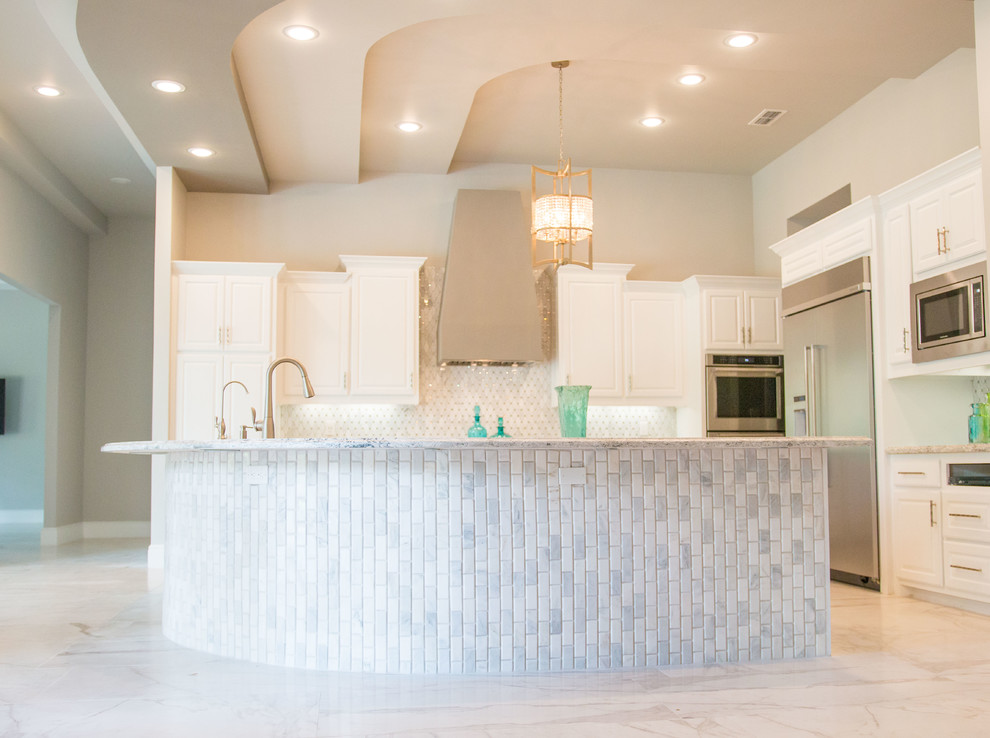 Example of a mid-sized transitional galley porcelain tile and white floor eat-in kitchen design with raised-panel cabinets, white cabinets, quartz countertops, white backsplash, stainless steel appliances and an island