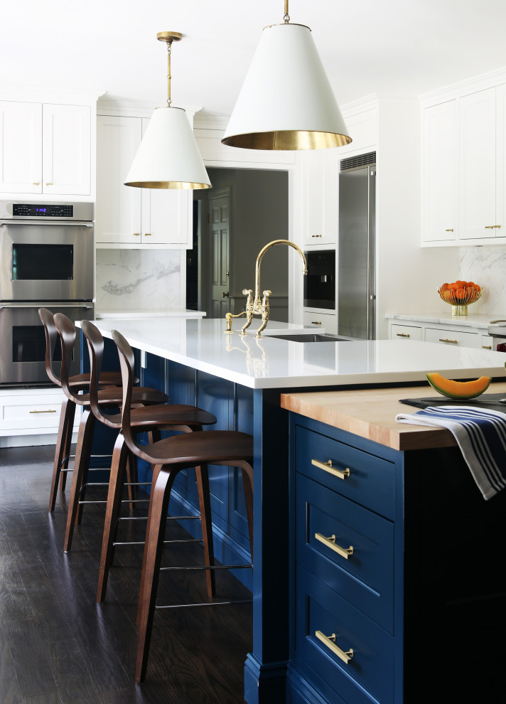 Kitchen - large transitional u-shaped brown floor kitchen idea in New York with an undermount sink, shaker cabinets, blue cabinets, gray backsplash, stainless steel appliances, an island and white countertops