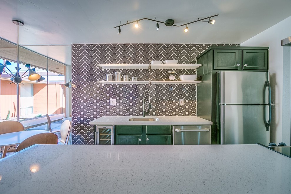 Mid-sized midcentury kitchen in Phoenix with an undermount sink, shaker cabinets, green cabinets, terrazzo benchtops, grey splashback, porcelain splashback, stainless steel appliances and with island.