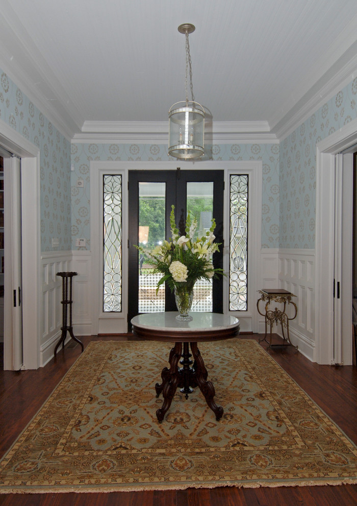 Photo of a traditional foyer in Other with dark hardwood floors and a double front door.