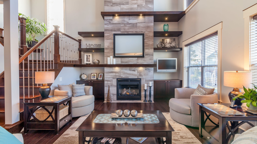 Inspiration for a mid-sized transitional open concept living room in Other with grey walls, dark hardwood floors, a standard fireplace, a tile fireplace surround and a wall-mounted tv.