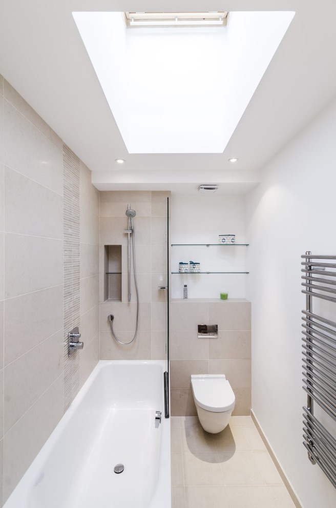 Inspiration for a mid-sized contemporary master bathroom in London with a shower/bathtub combo, a wall-mount toilet, beige tile, porcelain tile, white walls, porcelain floors and an alcove tub.
