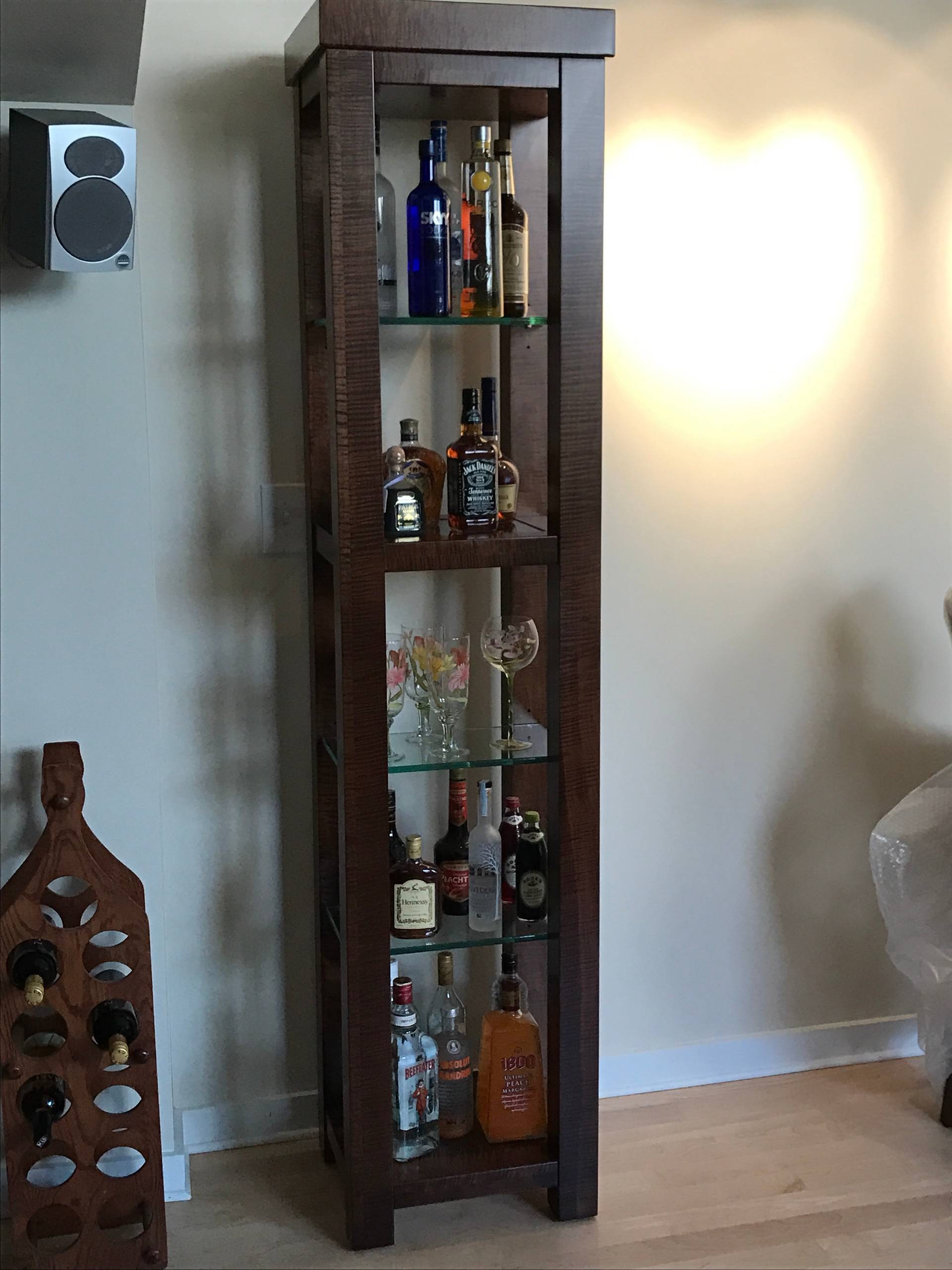 Custom built and designed bar cabinet in Tiger Maple with glass inlay and glass