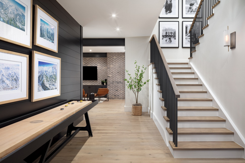 Transitional light wood floor, beige floor and shiplap wall basement game room photo in Denver with white walls