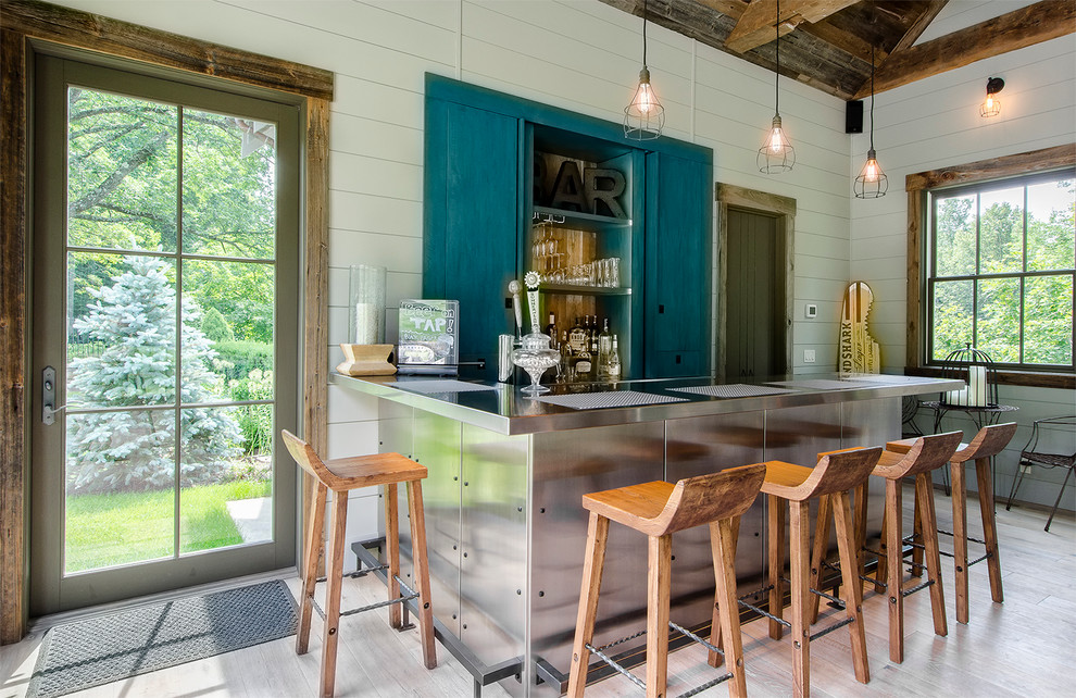 This is an example of a small beach style home bar in New York with light hardwood floors.