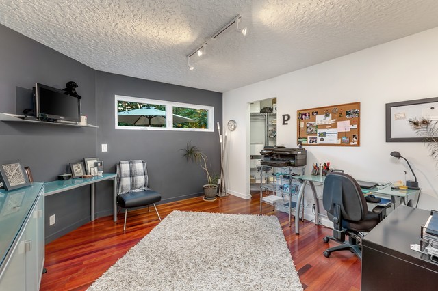 Inspiration for a small modern dark wood floor and multicolored floor home office remodel in Portland with gray walls