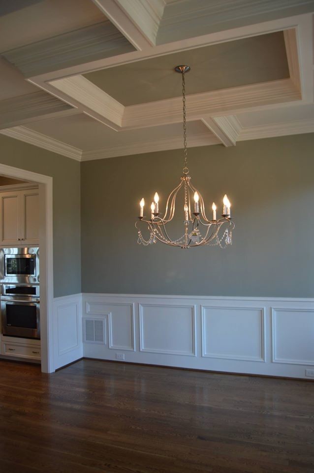 This is an example of a mid-sized traditional kitchen/dining combo in Raleigh with green walls and medium hardwood floors.