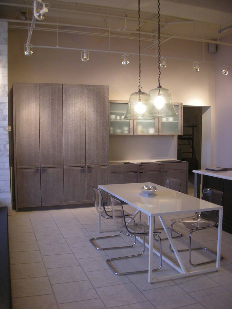 This is an example of a modern kitchen in Boston with glass-front cabinets and light wood cabinets.