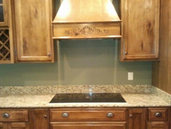 Example of a large galley eat-in kitchen design with a drop-in sink, beaded inset cabinets, medium tone wood cabinets, beige backsplash, stainless steel appliances and an island