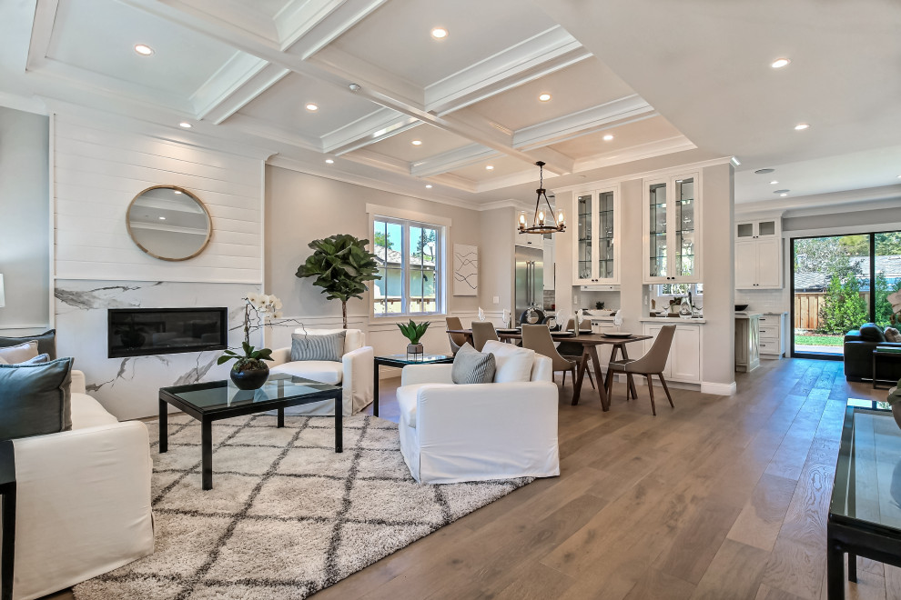 Living room - mid-sized craftsman formal and open concept medium tone wood floor, gray floor, coffered ceiling and wainscoting living room idea in San Francisco with gray walls, a ribbon fireplace, a stone fireplace and a wall-mounted tv