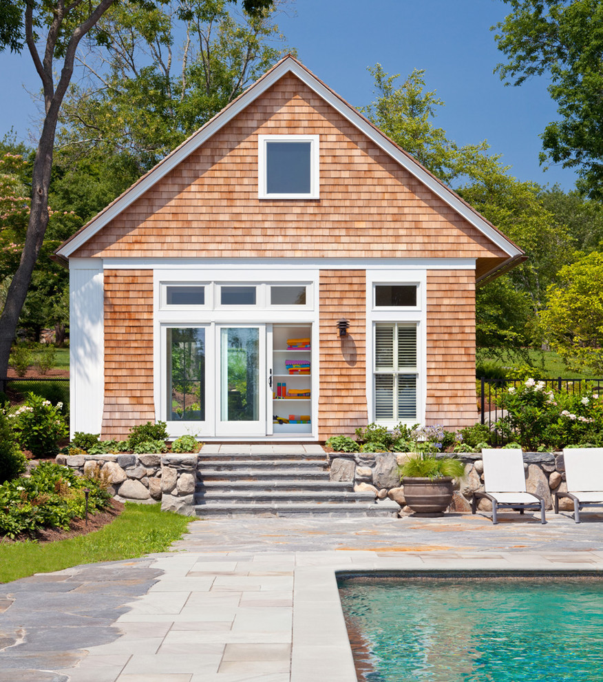 This is an example of a beach style pool in Providence with a pool house.