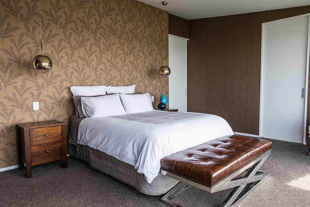 This is an example of a mid-sized contemporary master bedroom in Auckland with brown walls, carpet and grey floor.