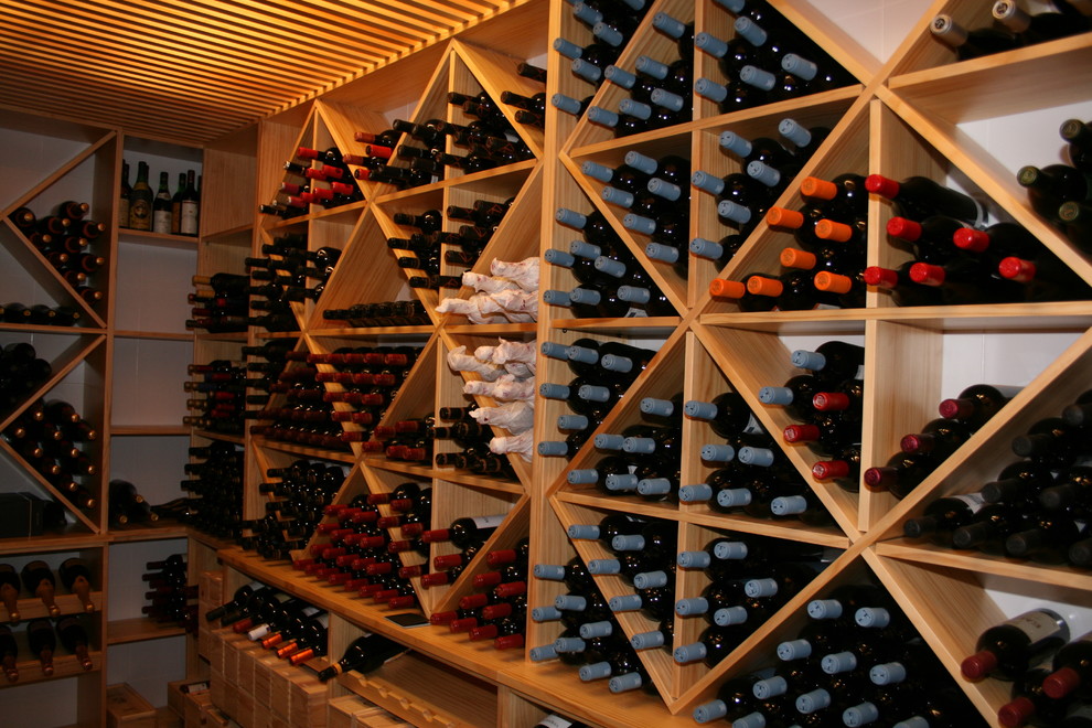 Mid-sized traditional wine cellar in Other with diamond bins.