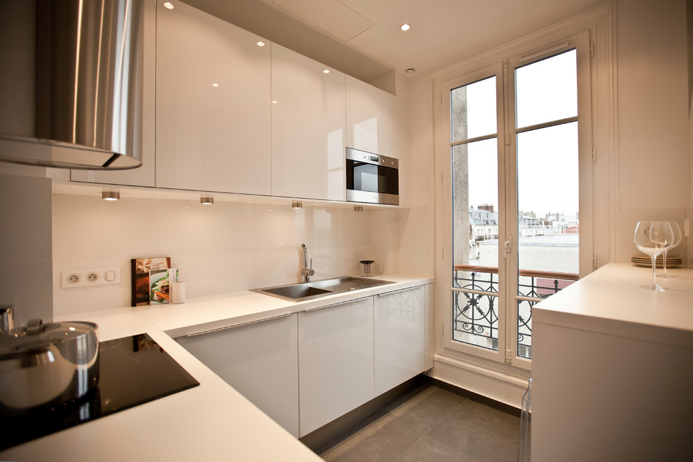 Inspiration for a small contemporary l-shaped separate kitchen in Paris with a single-bowl sink, beaded inset cabinets, white cabinets, laminate benchtops, white splashback, ceramic splashback, stainless steel appliances and ceramic floors.