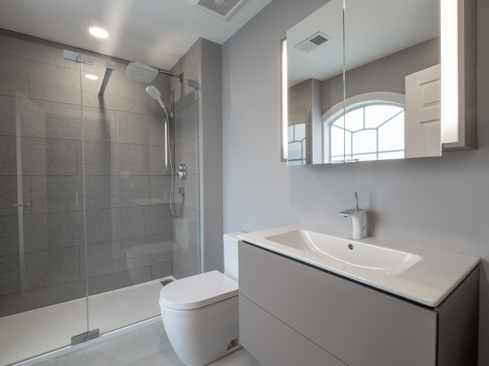 Small contemporary kids bathroom in Other with flat-panel cabinets, grey cabinets, gray tile, porcelain tile, grey walls, porcelain floors, an integrated sink, engineered quartz benchtops, grey floor, a sliding shower screen and white benchtops.