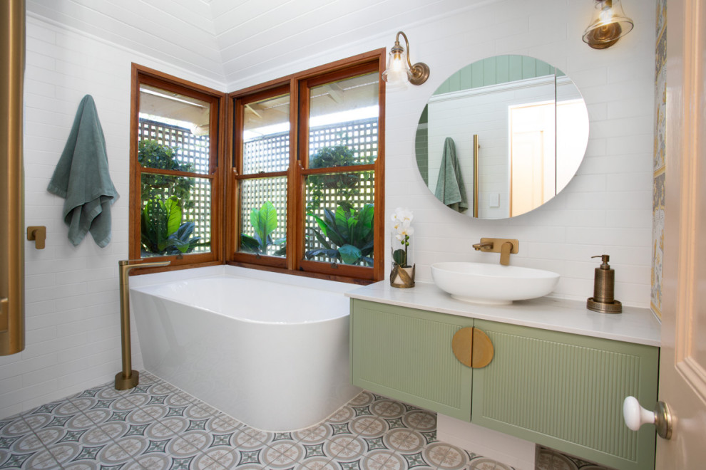 Inspiration for a mid-sized traditional bathroom in Brisbane with shaker cabinets, green cabinets, a corner tub, an open shower, multi-coloured tile, subway tile, multi-coloured walls, porcelain floors, a vessel sink, engineered quartz benchtops, multi-coloured floor, an open shower, white benchtops, a shower seat, a single vanity, a floating vanity, timber and wood walls.