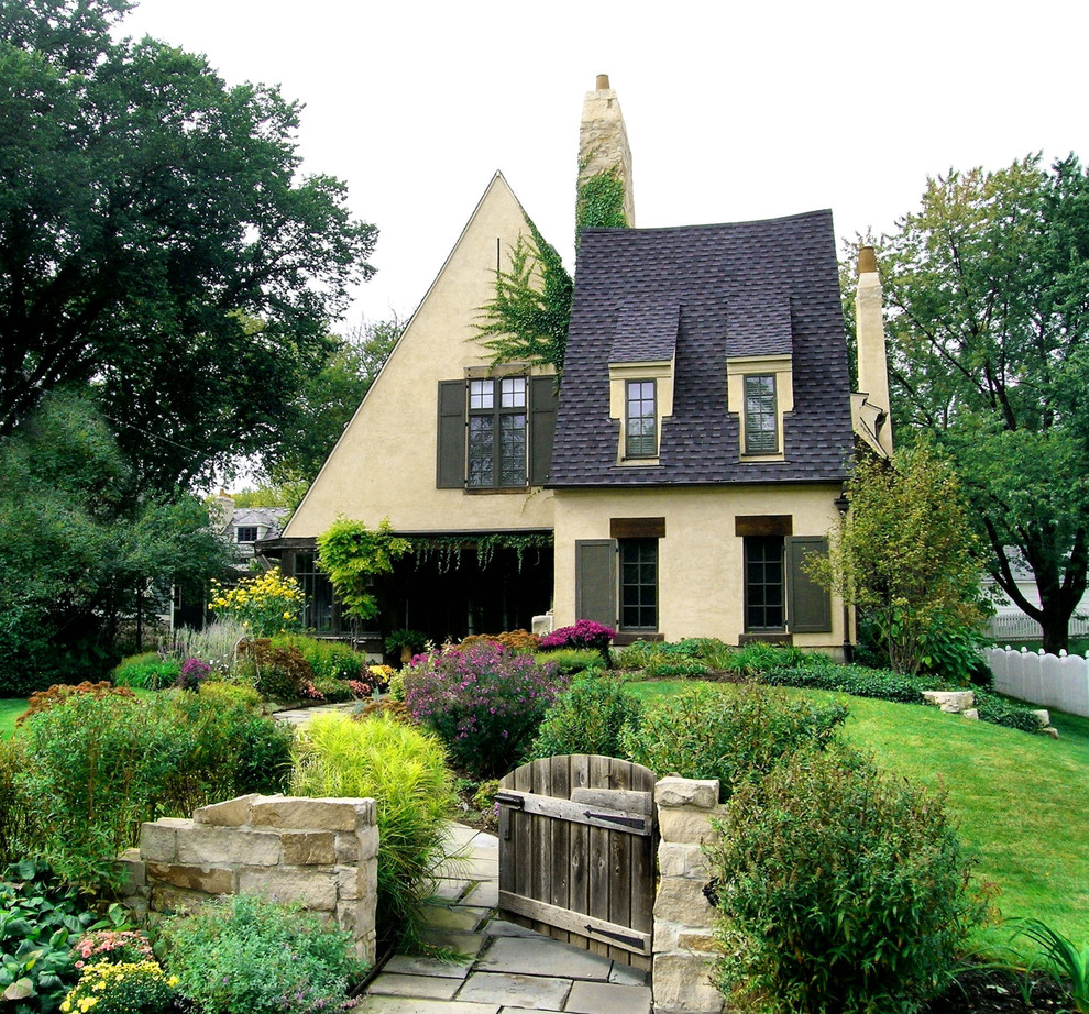 Inspiration for a large traditional two-storey concrete yellow house exterior in Chicago with a shingle roof.
