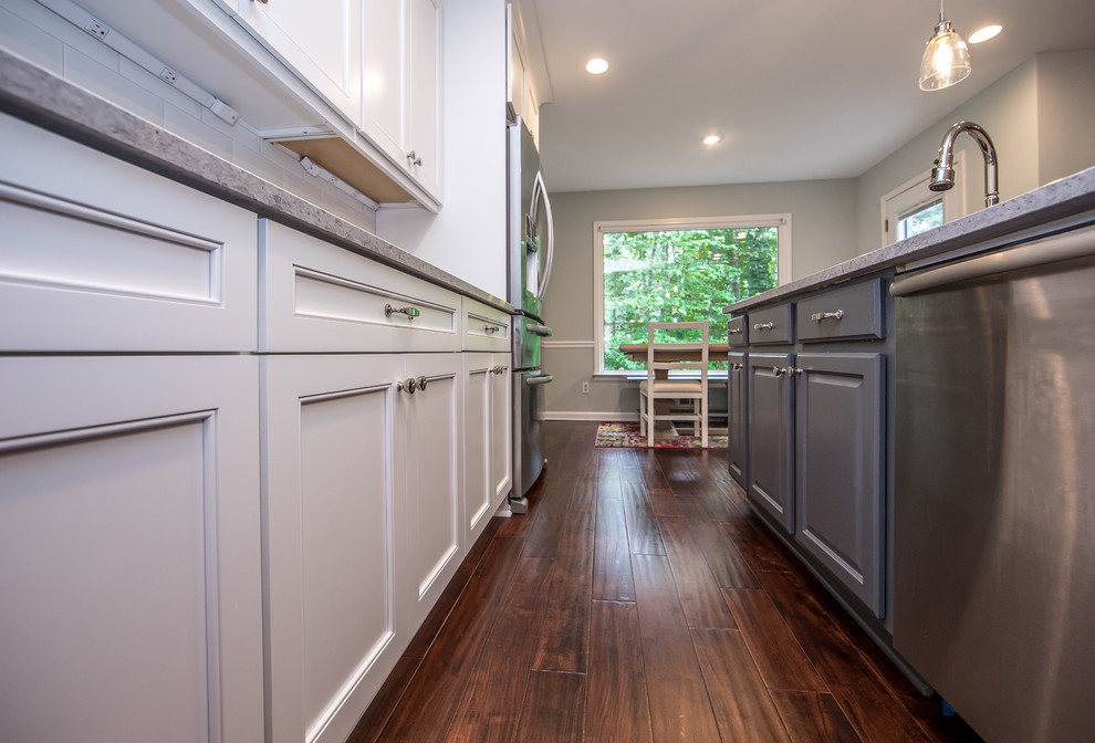 Mid-sized transitional l-shaped brown floor eat-in kitchen photo in Atlanta with an undermount sink, white cabinets, quartzite countertops, white backsplash, subway tile backsplash, stainless steel appliances, an island and gray countertops