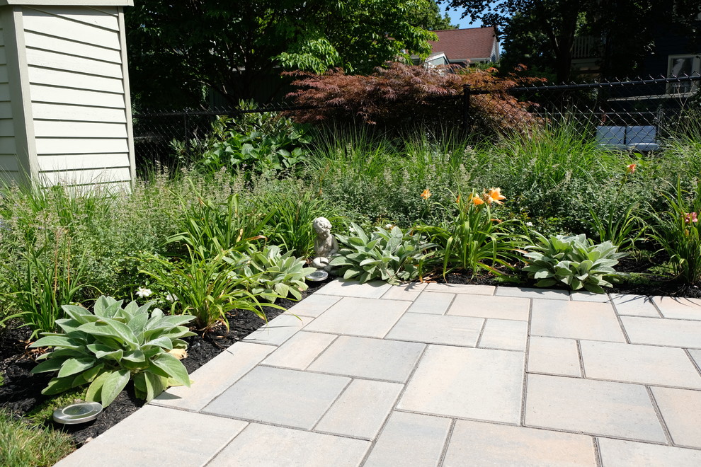 Photo of a mid-sized contemporary backyard full sun formal garden for summer in Boston with a water feature and concrete pavers.