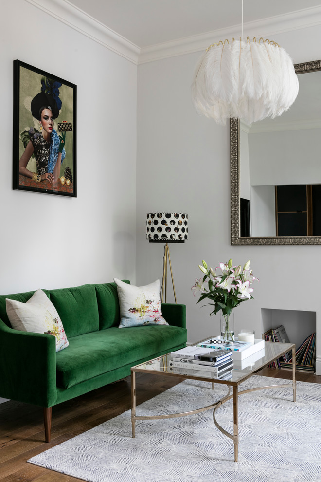 This is an example of an eclectic living room in London with grey walls and dark hardwood flooring.