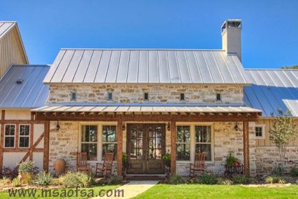 Inspiration for a country two-storey exterior in Austin with stone veneer.