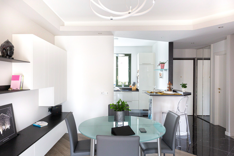 This is an example of a contemporary open plan dining in Other with beige walls, porcelain floors and brick walls.