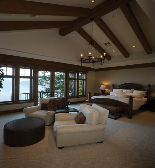 Expansive traditional master bedroom in Phoenix with beige walls, carpet and beige floor.
